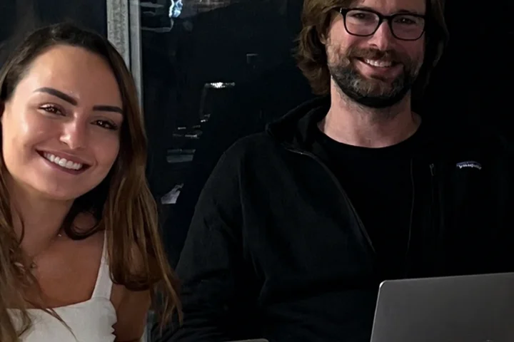 Danielle Vantini and Jarad working together on laptops at a San Diego session, early 2026