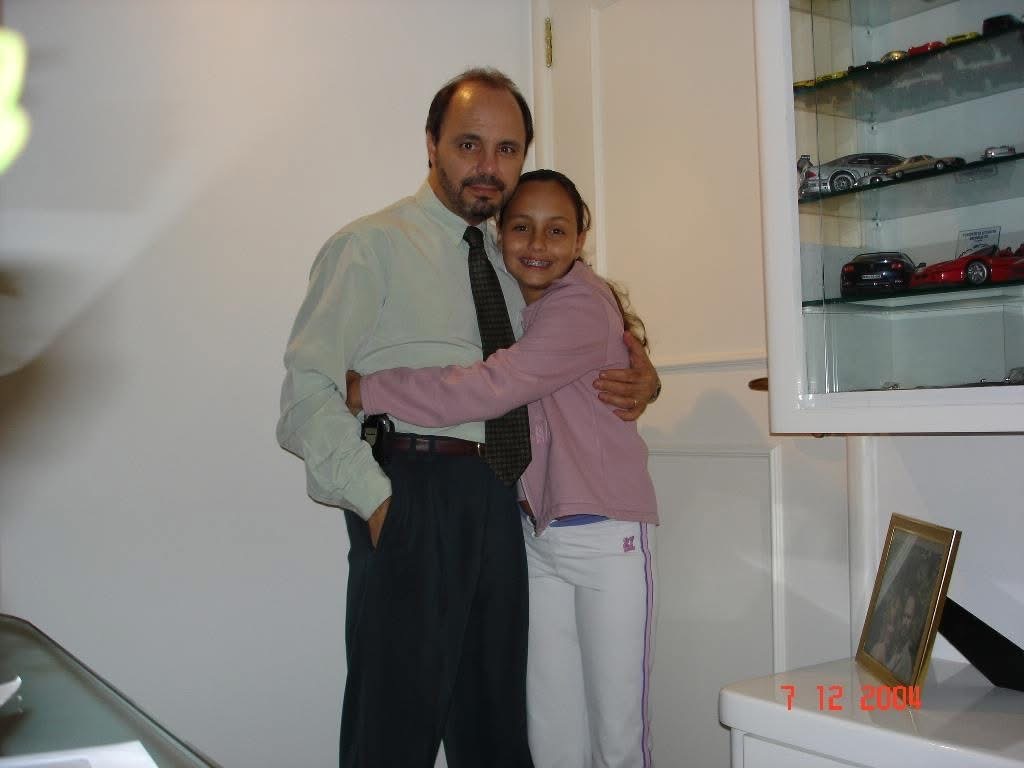 Danielle, age 10, hugging her father at home — São Paulo 2000