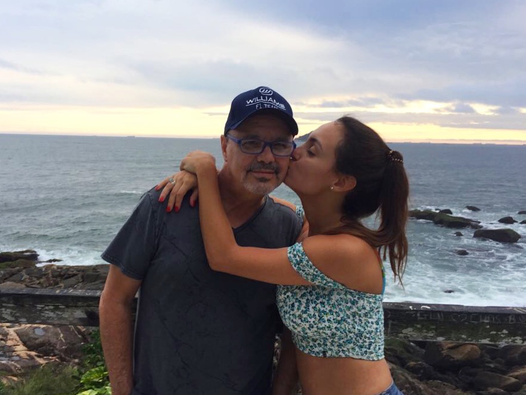 Danielle kissing her father on the beach in Brazil
