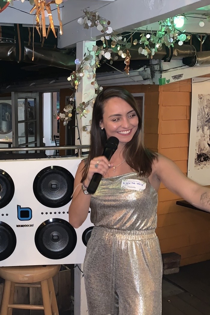 Danielle Vantini on stage smiling with microphone