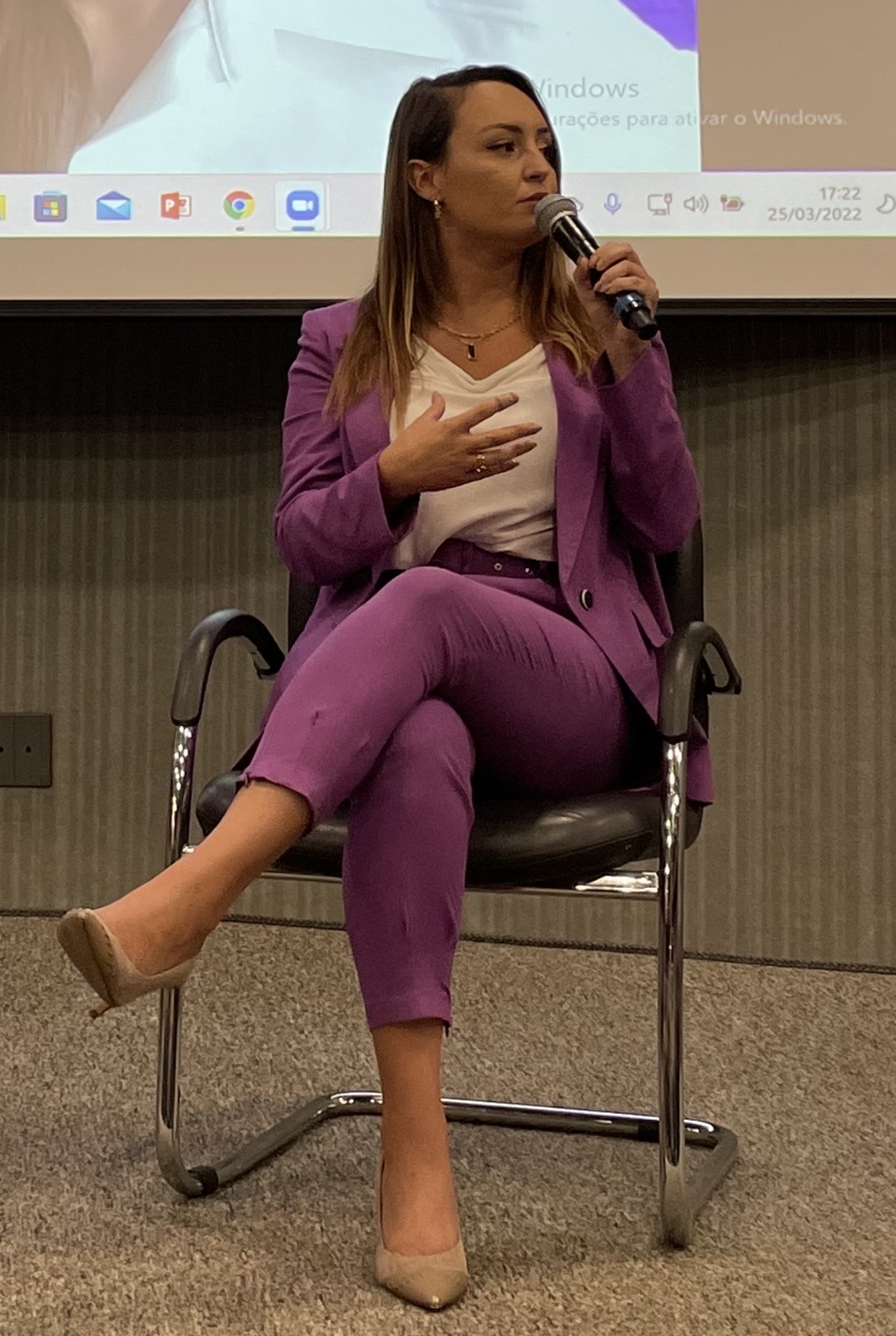 Danielle Vantini speaking on panel with microphone — São Paulo 2022